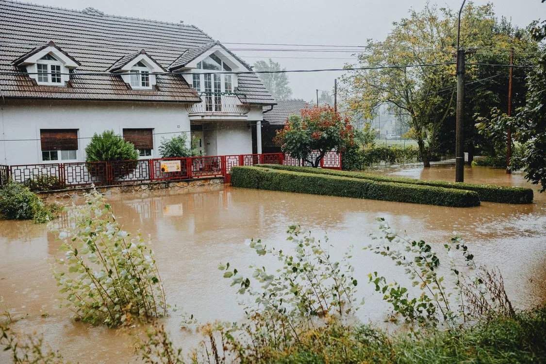 Suburban home surrounded by floodwater after heavy rain